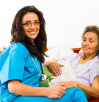 caregiver and elder woman smiling